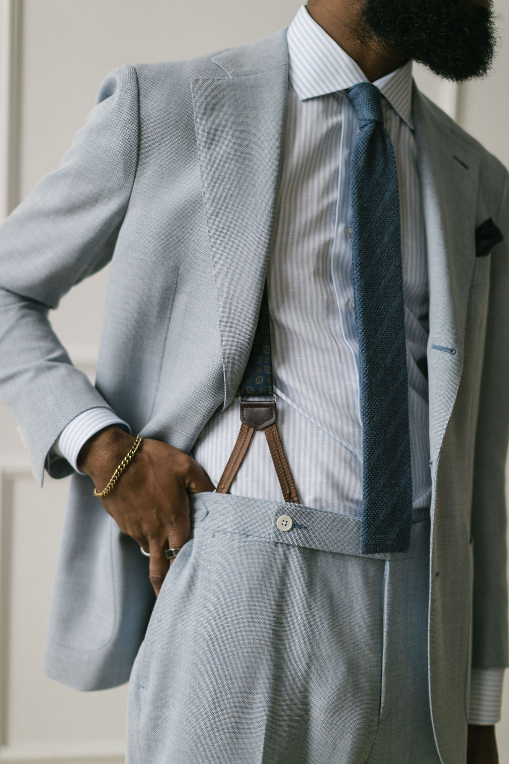 Brown linen suit with a tan knit tie
